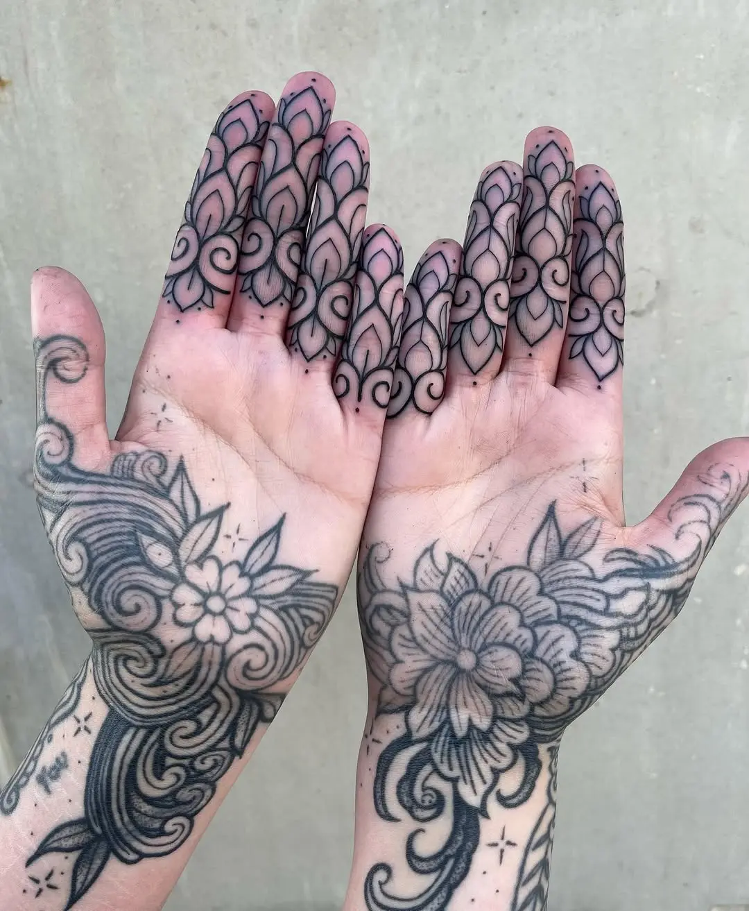 Intricate palm tattoos featuring floral designs