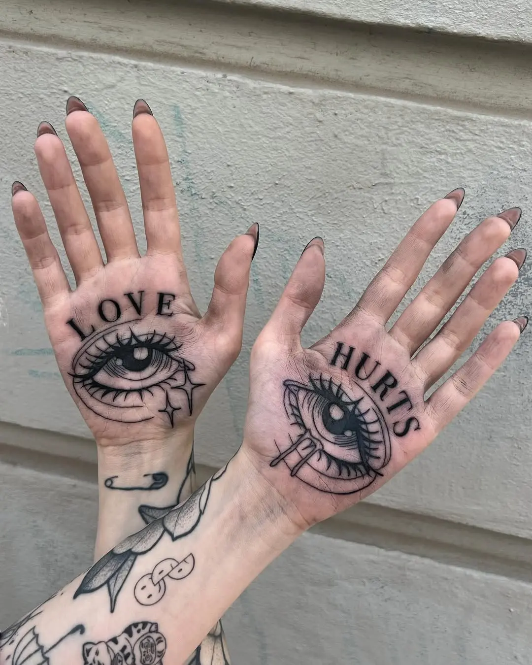 Unique palm tattoos expressing love and pain
