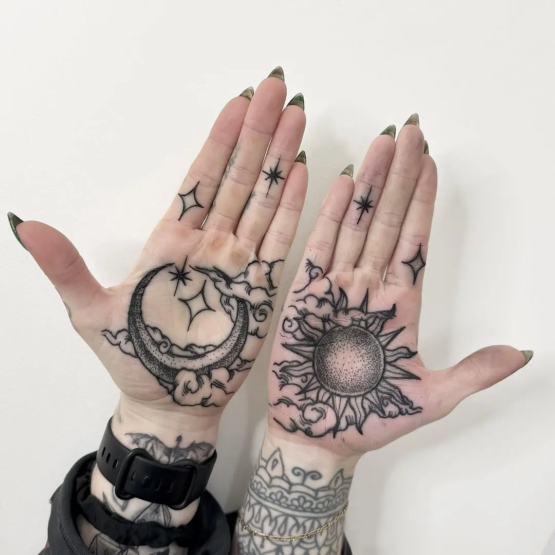 Intricate sun and moon palm tattoo designs