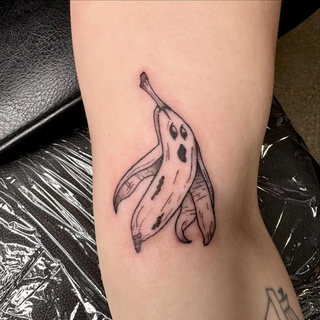 Unique banana tattoo with playful ghost faces