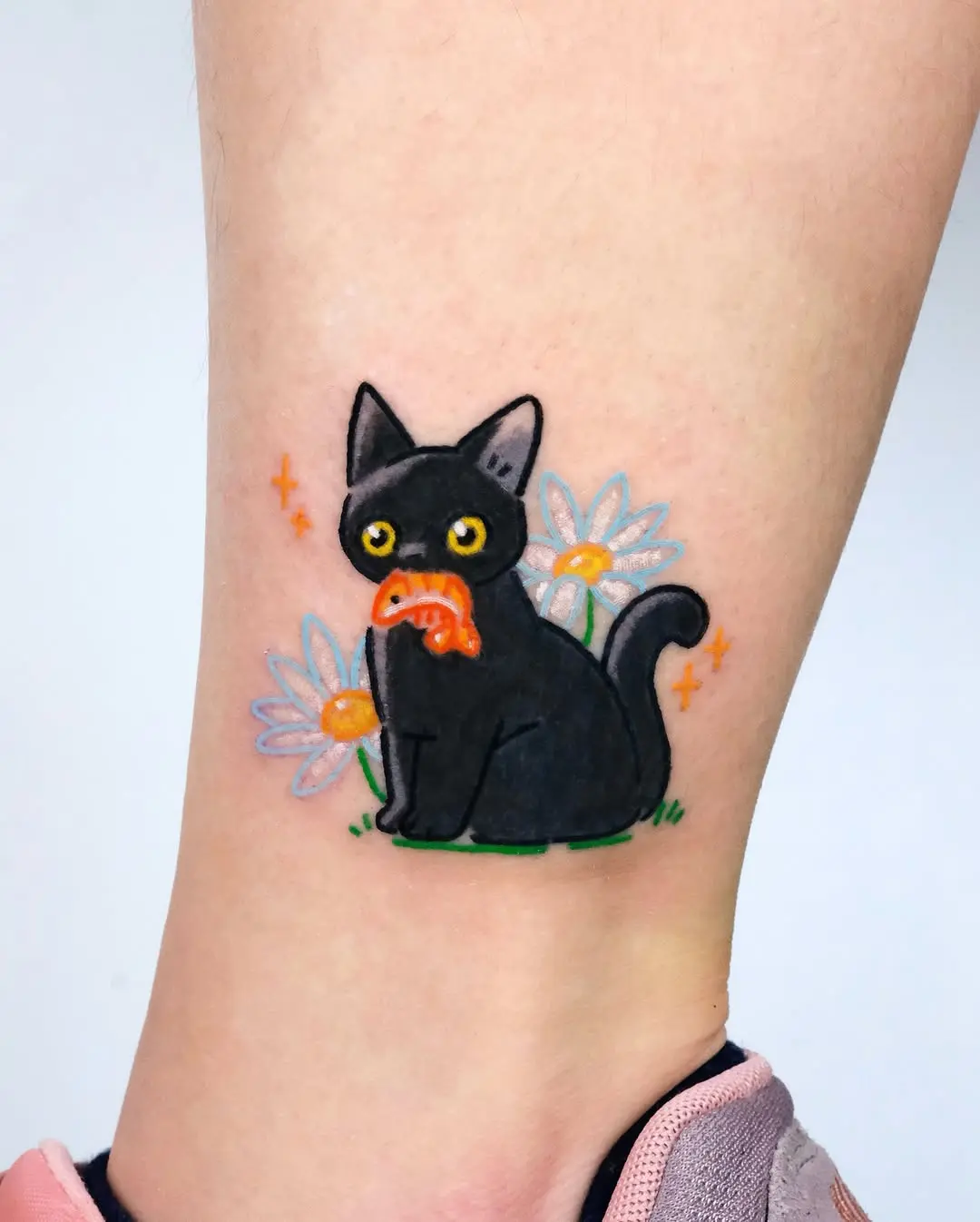 Playful black cat with food and flowers