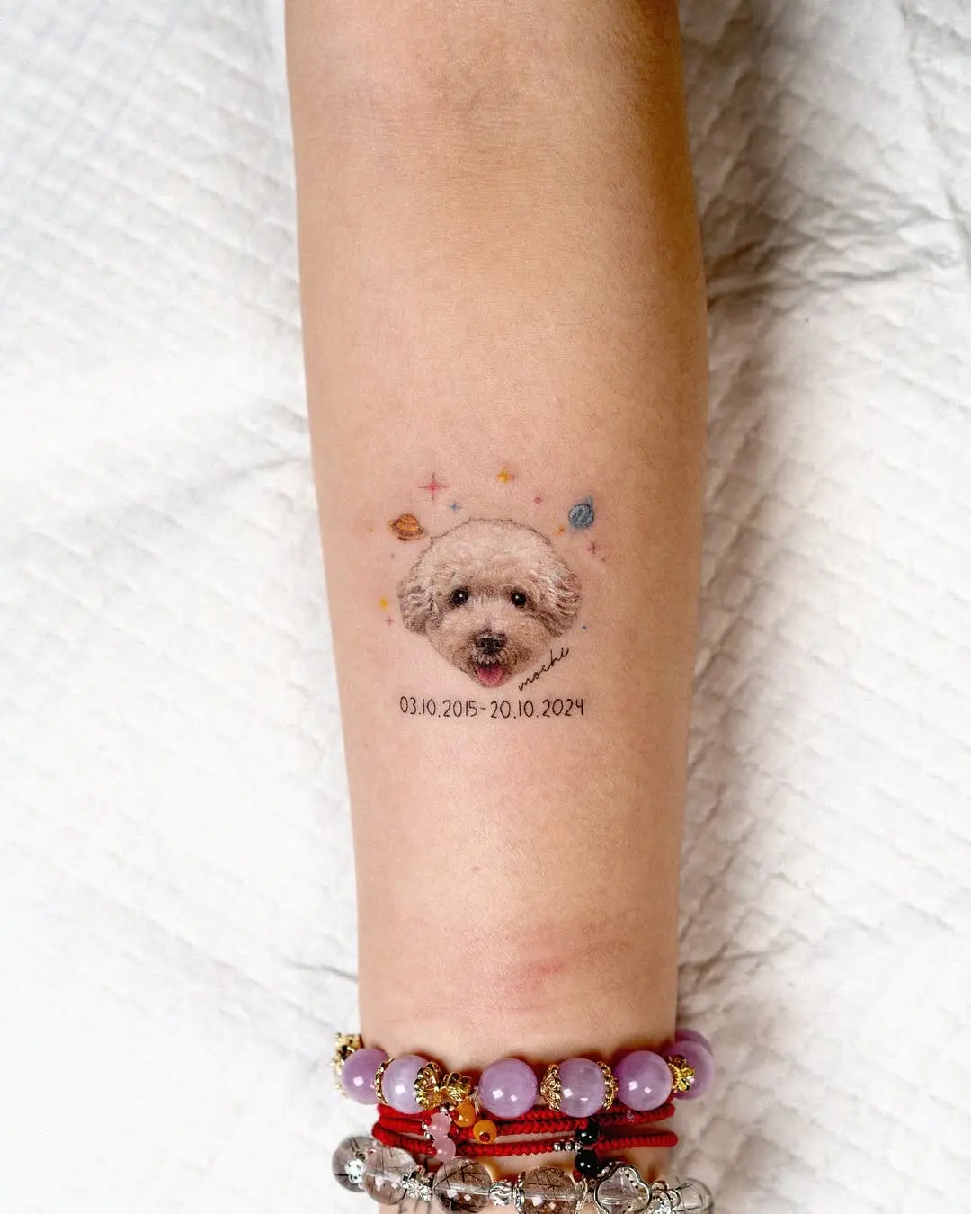 Adorable poodle tattoo with a cosmic twist