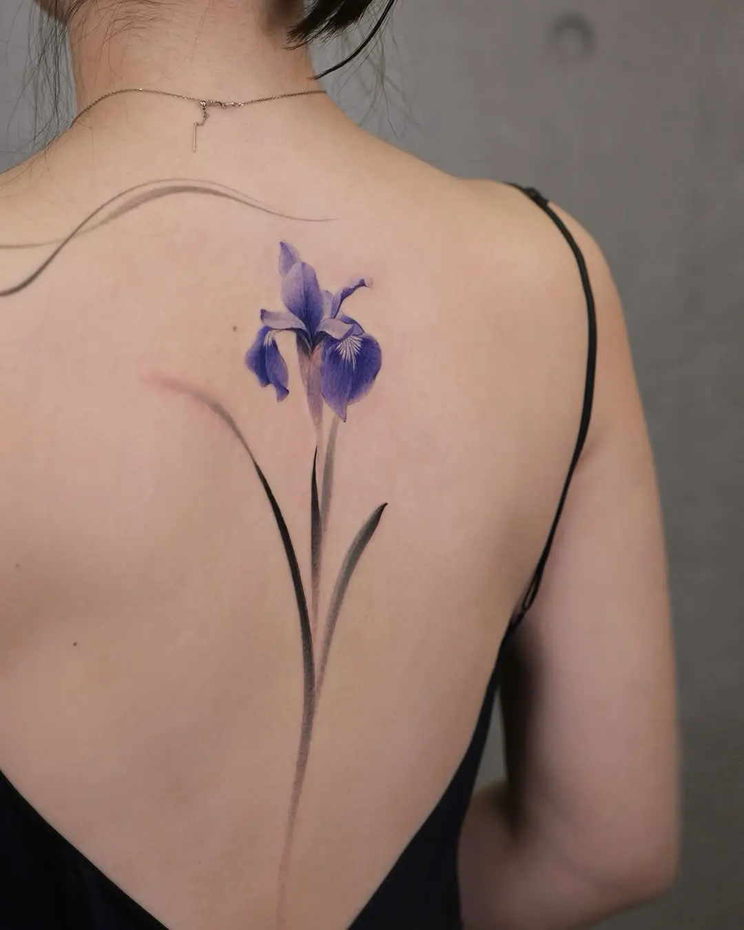 Elegant iris tattoo gracing the back