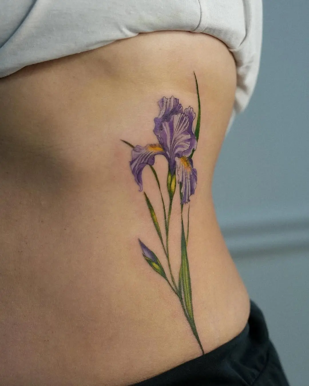 Stunning purple iris tattoo on the side