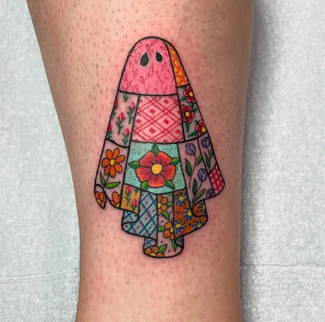 Unique quilt-inspired ghost tattoo with vibrant patches