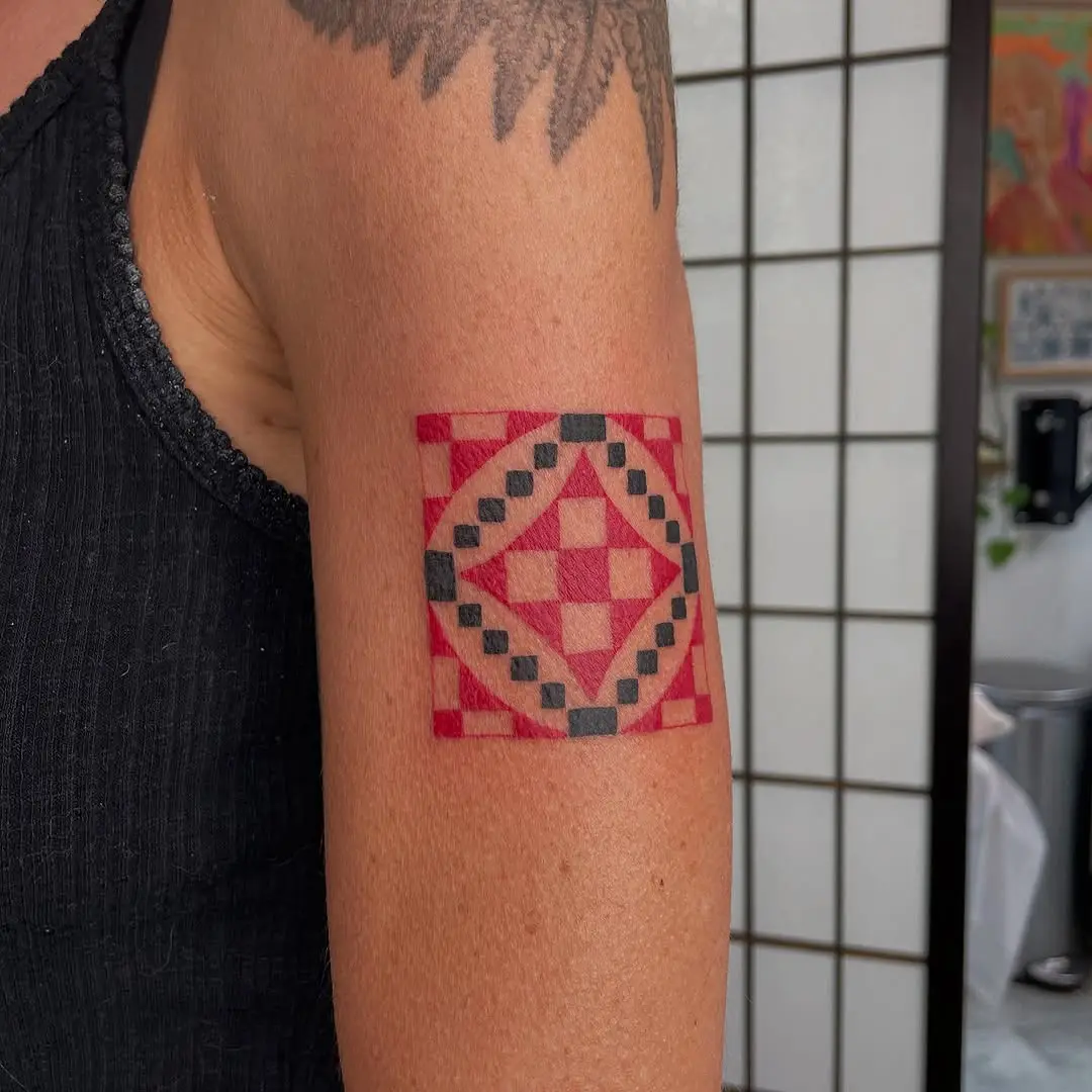 Vibrant quilt tattoo with geometric patterns