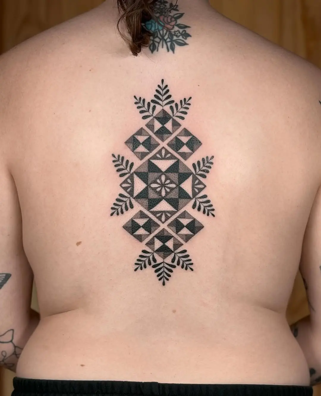 Intricate geometric quilt tattoo design for back