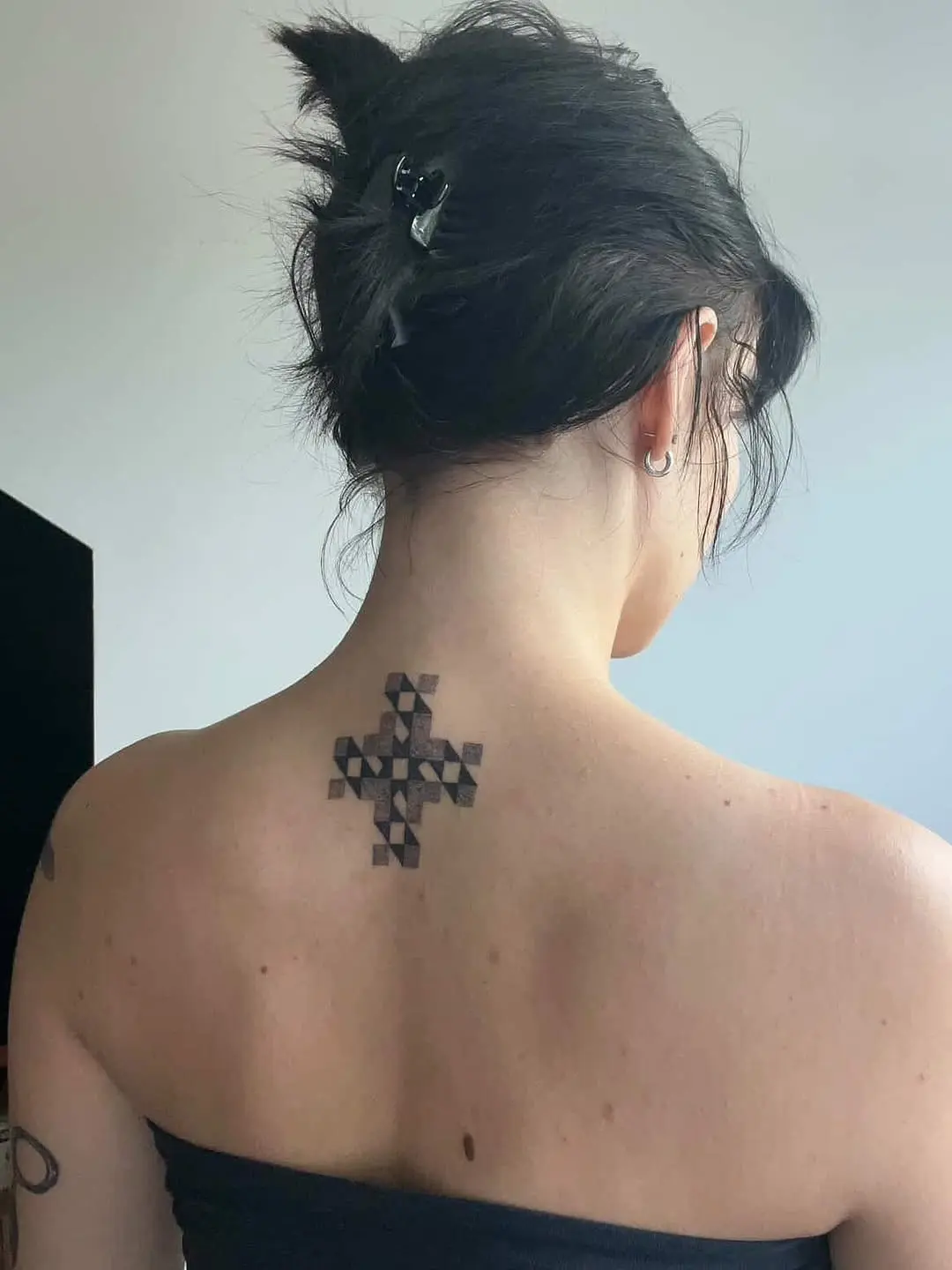 Unique quilt-inspired tattoo on the back.