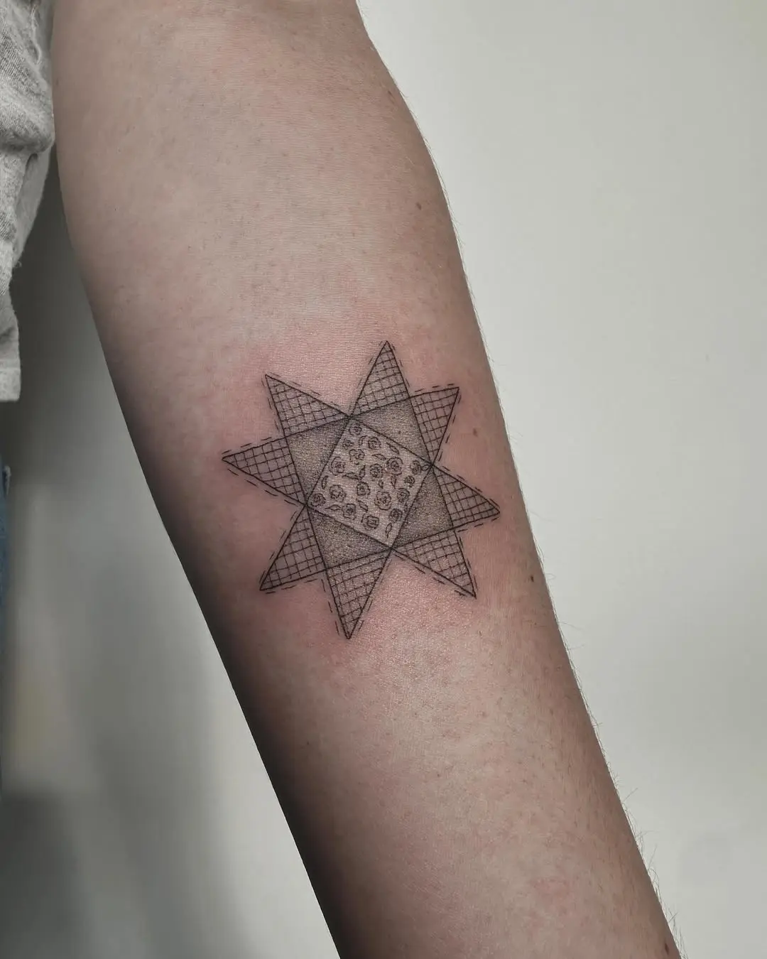 Intricate geometric quilt tattoo with star design