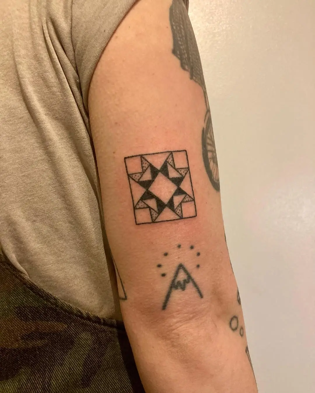 Geometric quilt tattoo on the arm