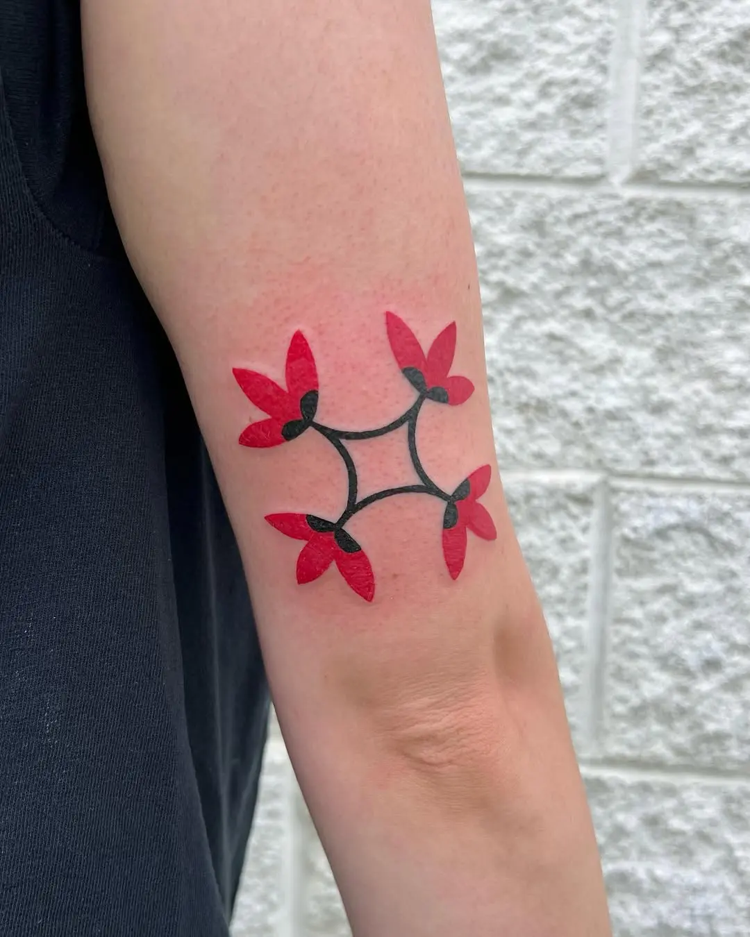 Vibrant Red and Black Floral Quilt Tattoo