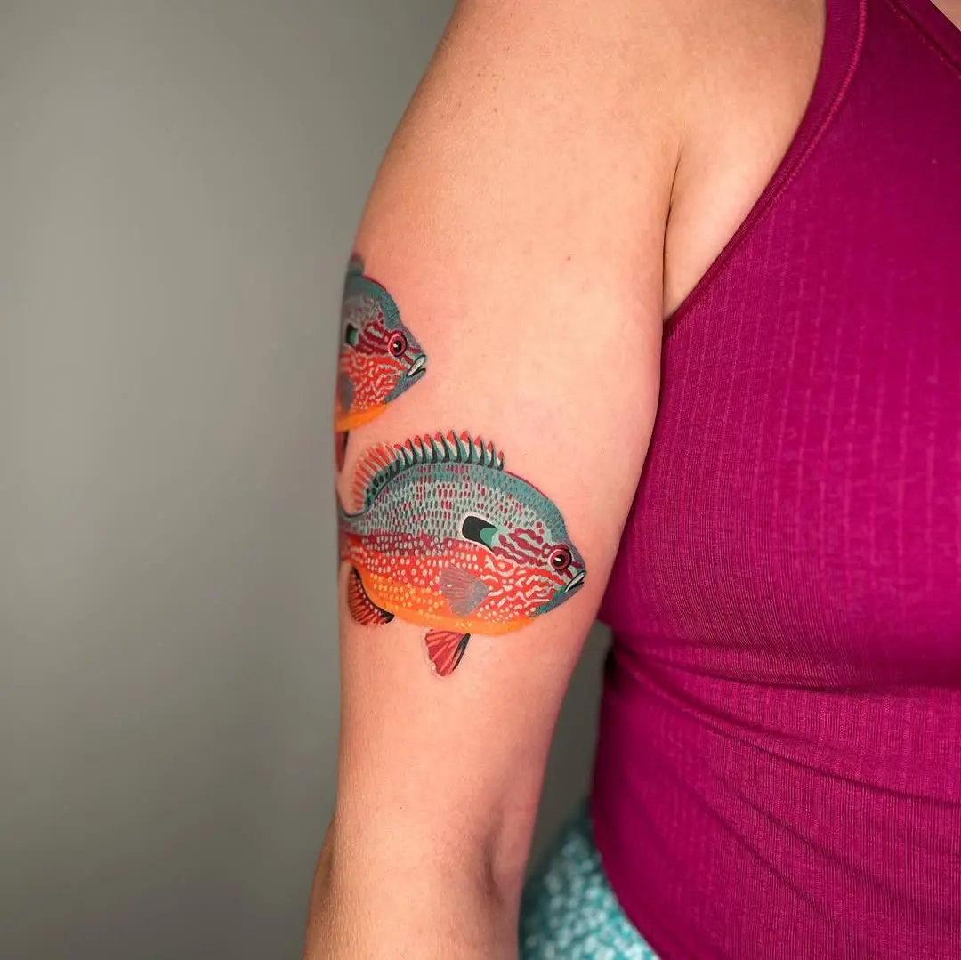 Vibrant quilt-inspired fish tattoo on arm