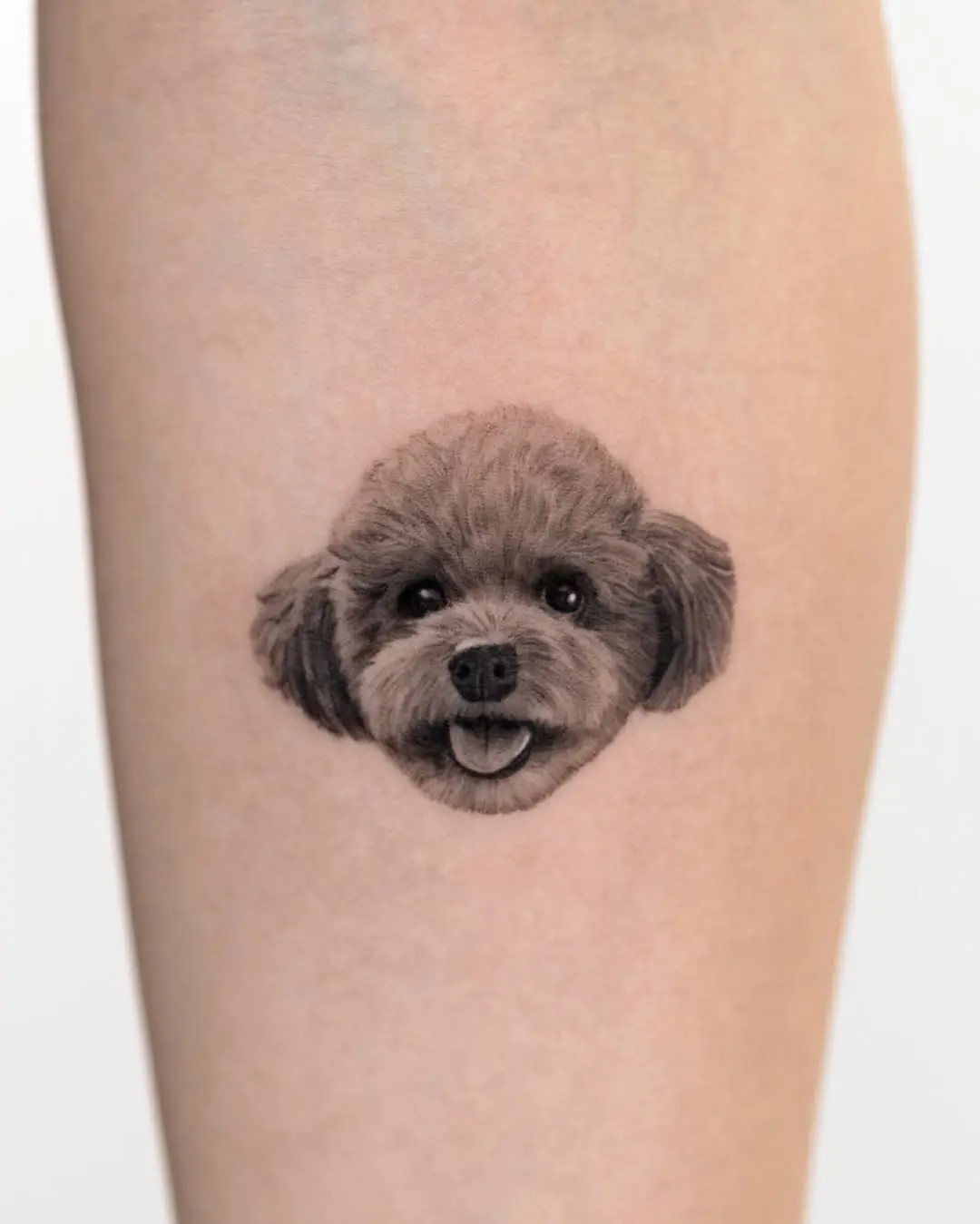 Charming poodle tattoo showcasing adorable puppy features