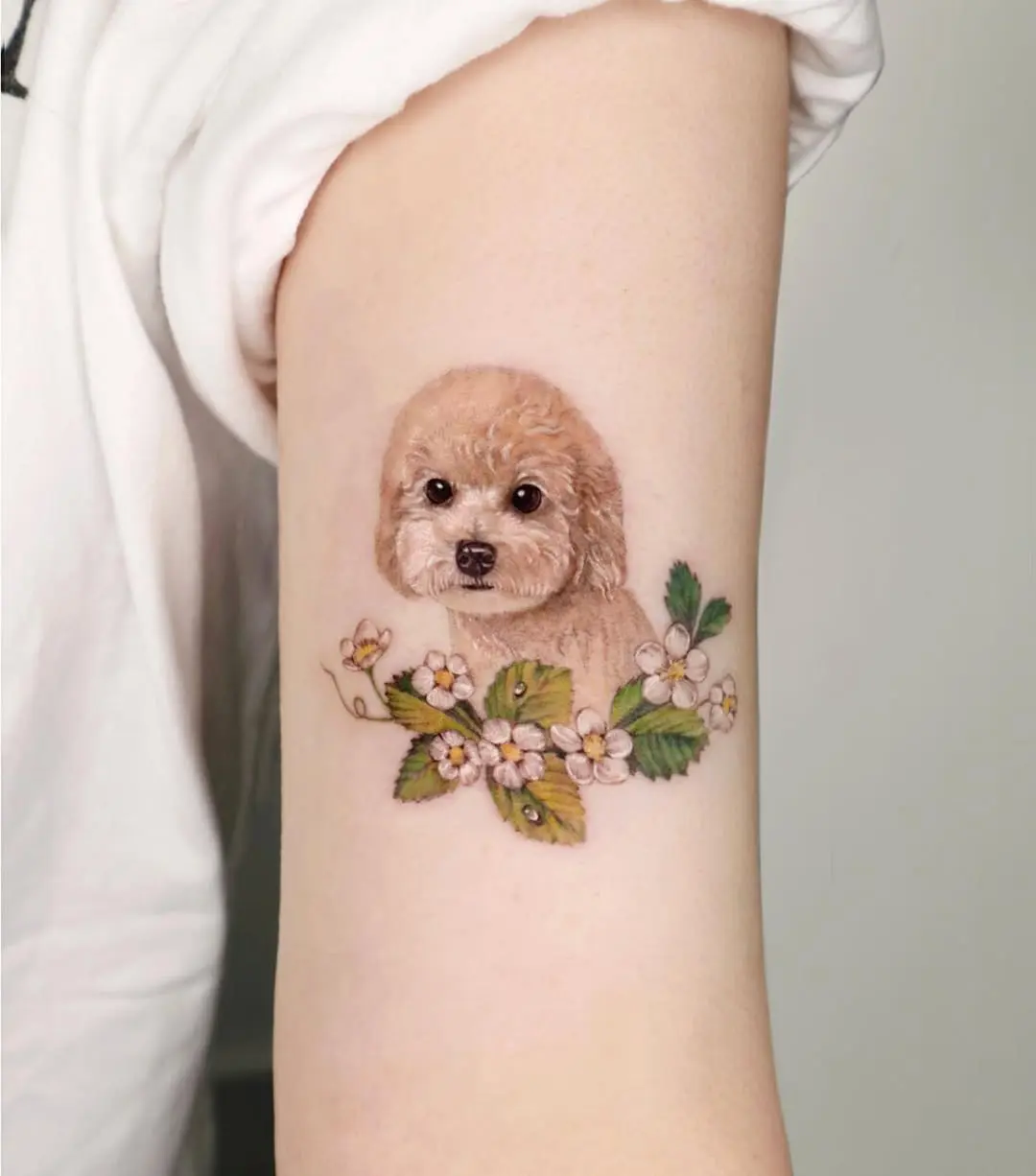 Charming realistic poodle tattoo with floral elements
