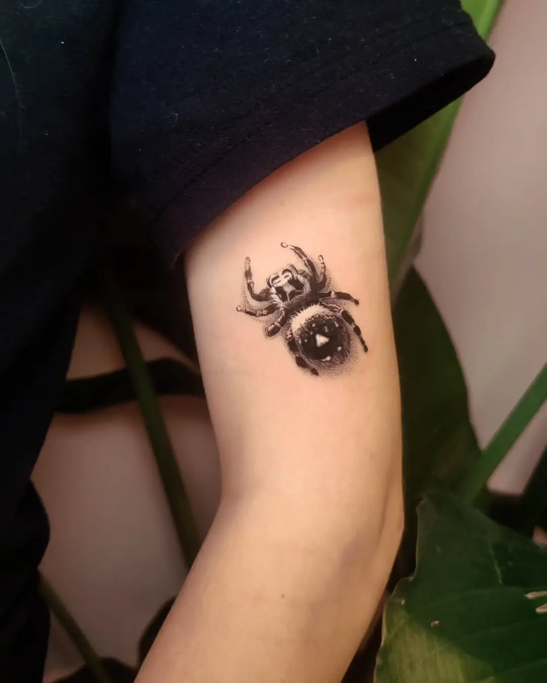 Intricate spider tattoo perched on the skin