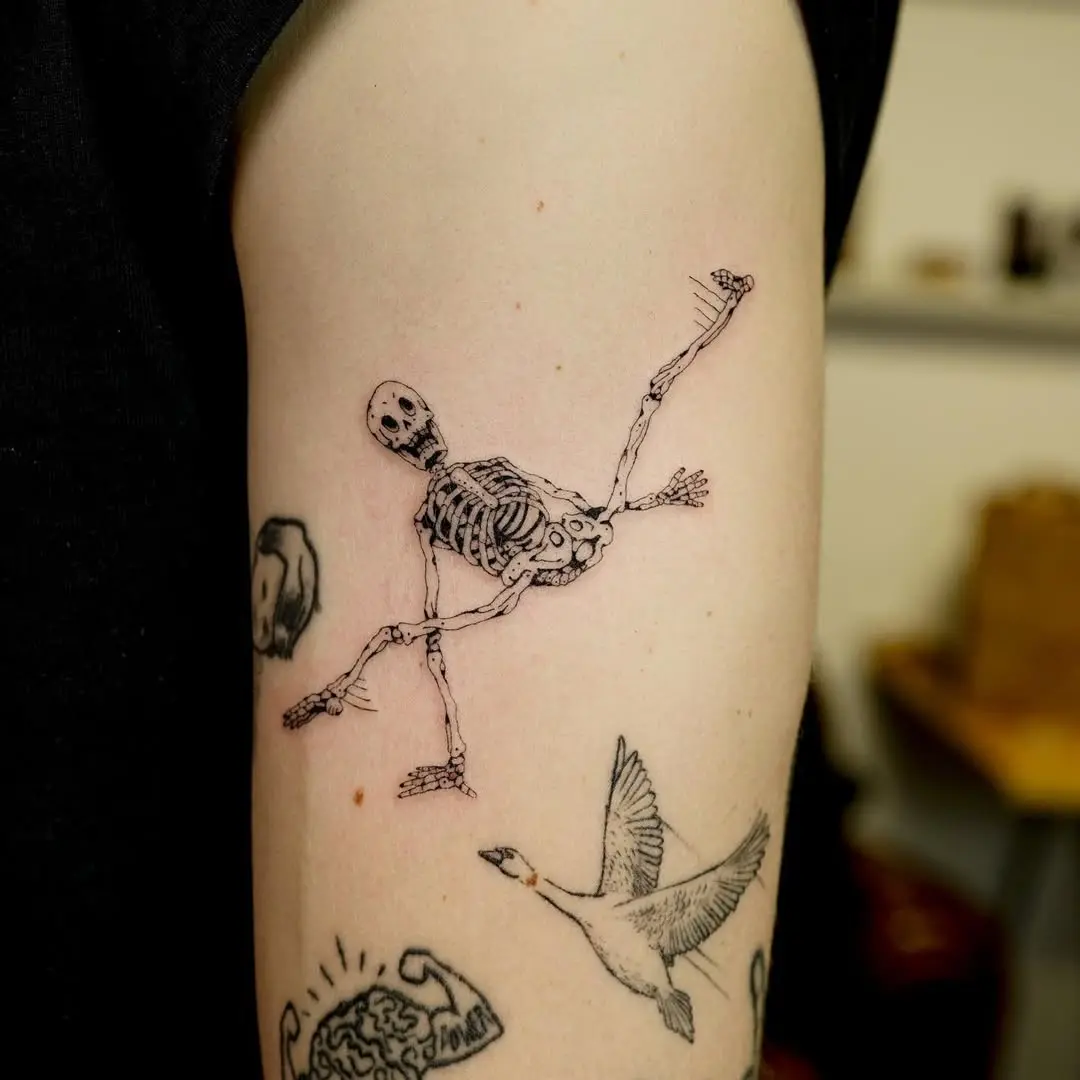 Expressive skeleton tattoo showcasing playful movement