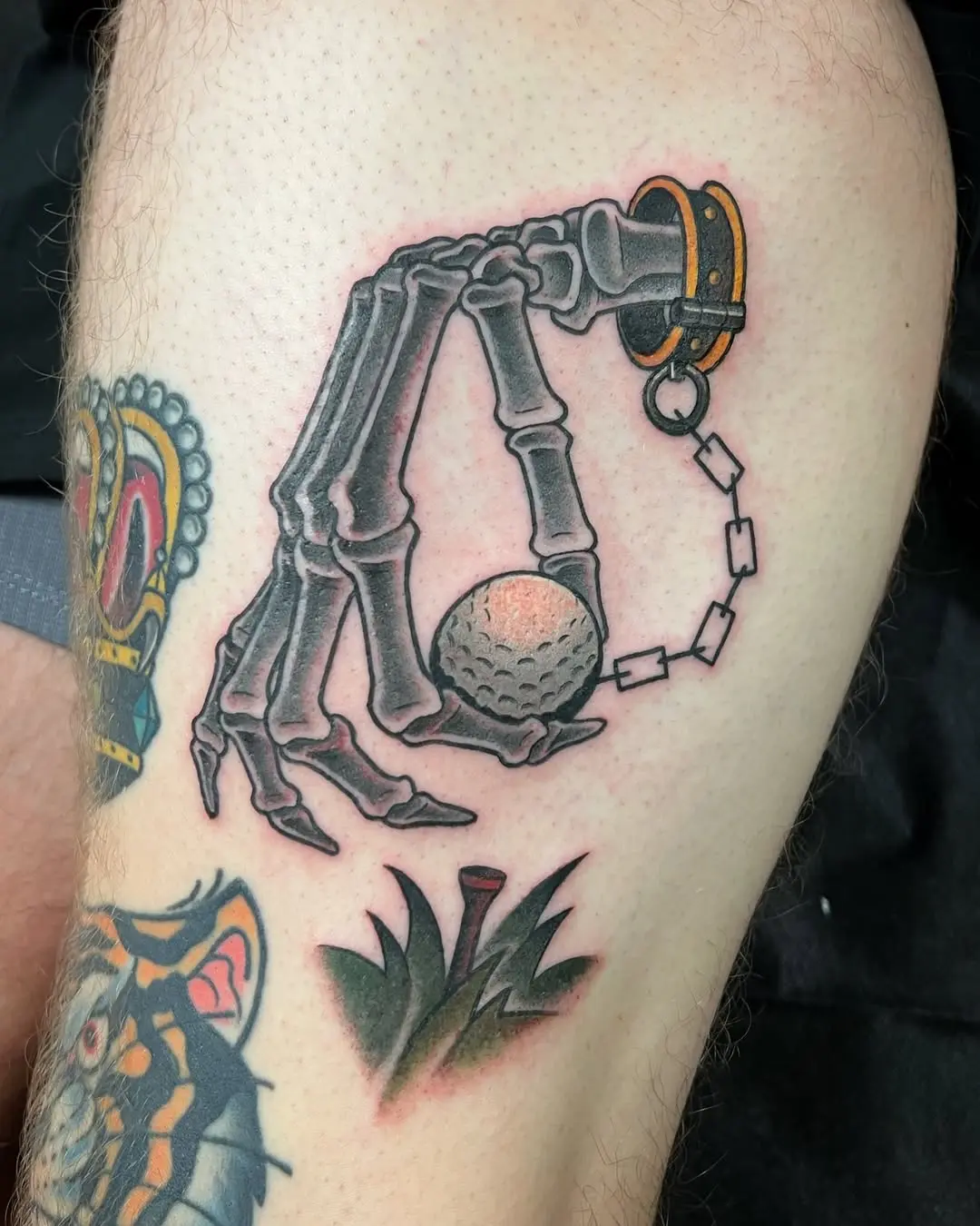 Intriguing skeleton hand with golf ball tattoo