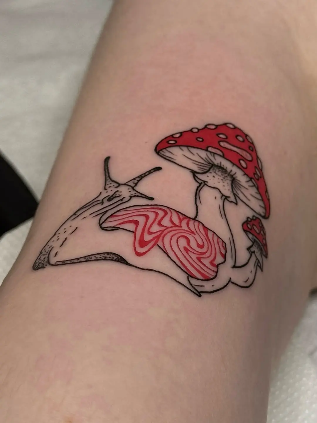 Charming snail and mushroom tattoo design
