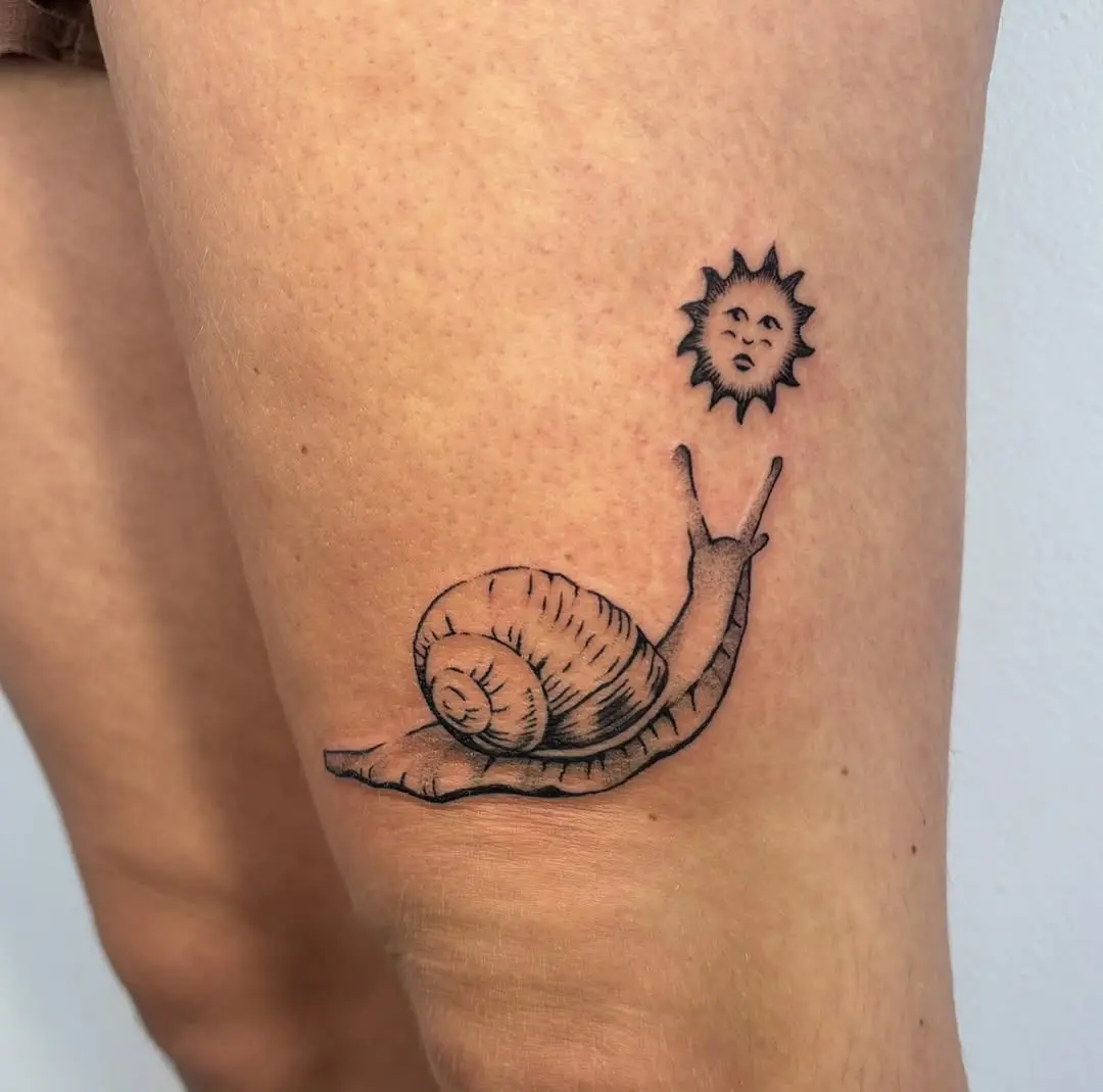 Charming snail tattoo with a sun illustration