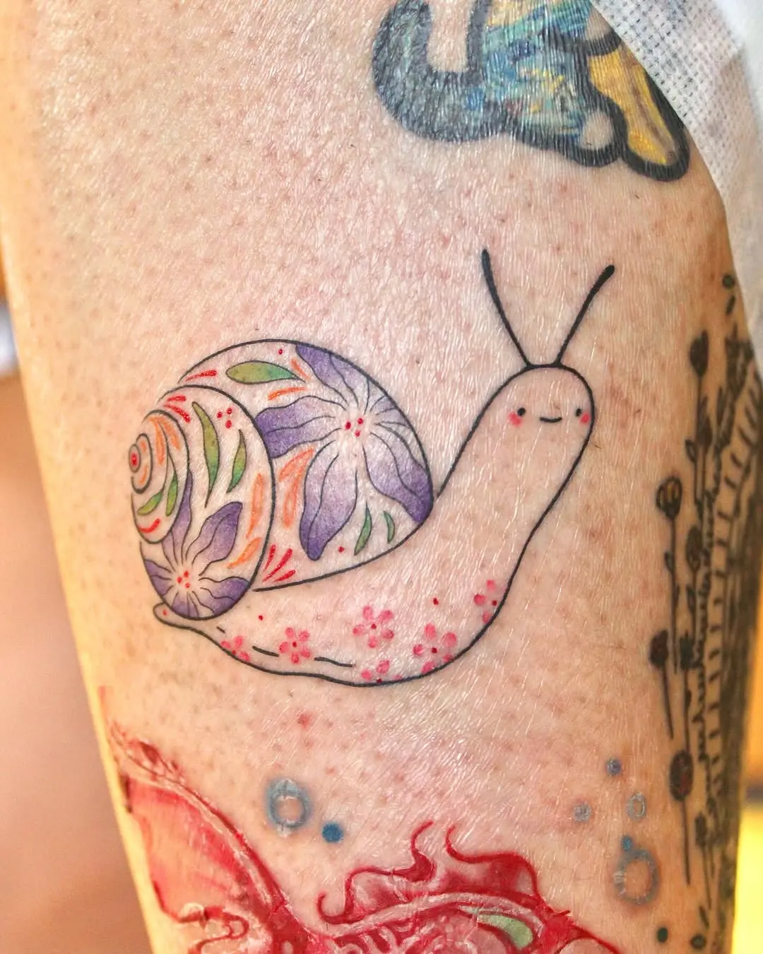 Whimsical Snail Tattoo with Floral Patterns