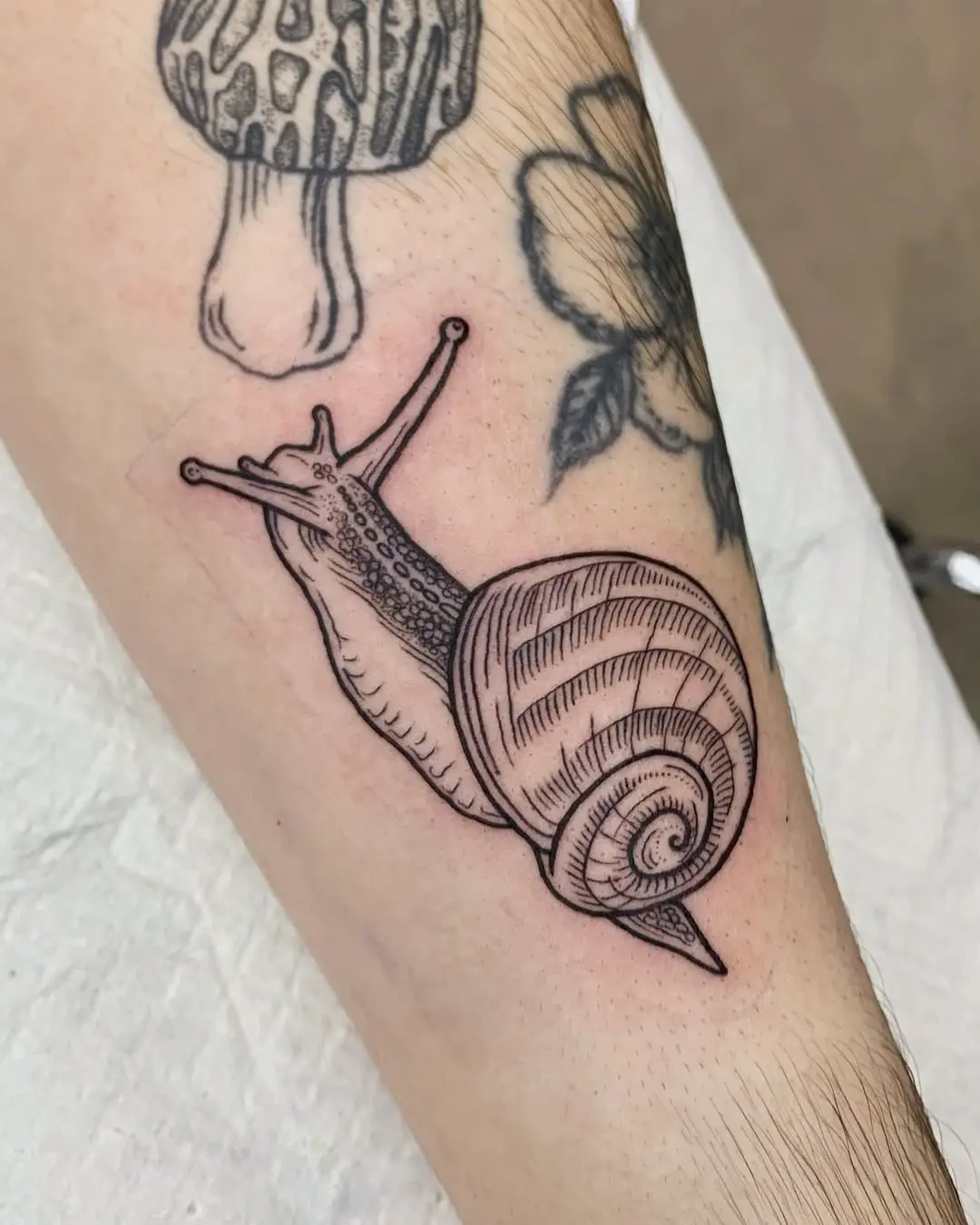 Charming snail tattoo showcasing unique design elements