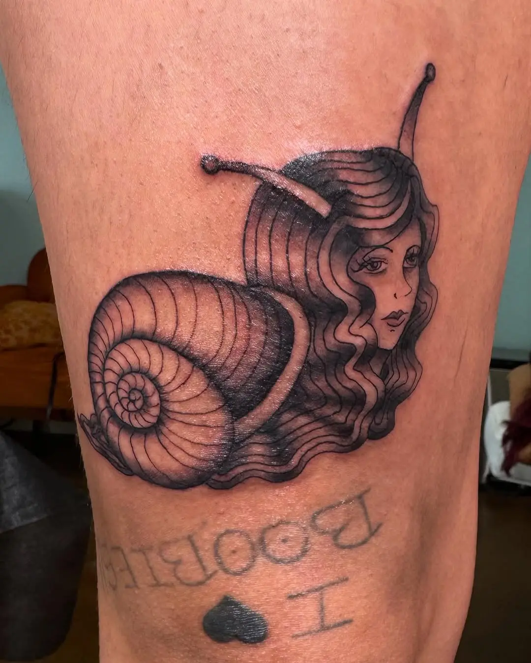 Ethereal snail tattoo blending beauty and nature