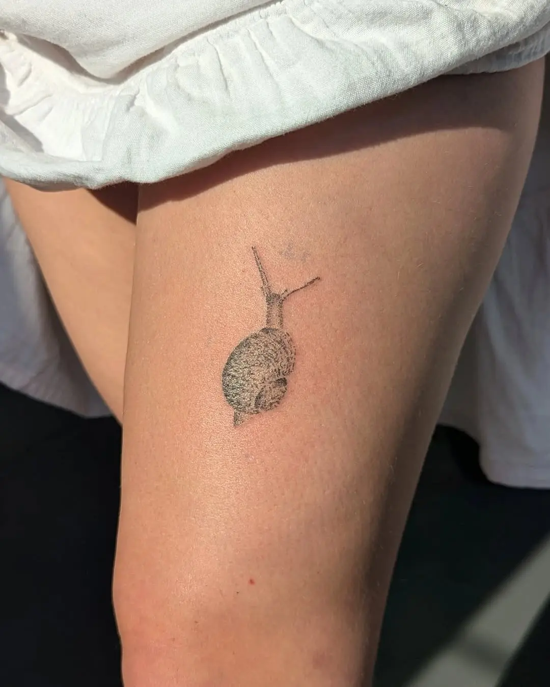 Charming Minimalist Snail Tattoo on Thigh