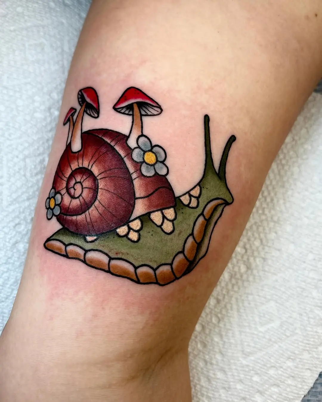 Charming snail tattoo with whimsical details