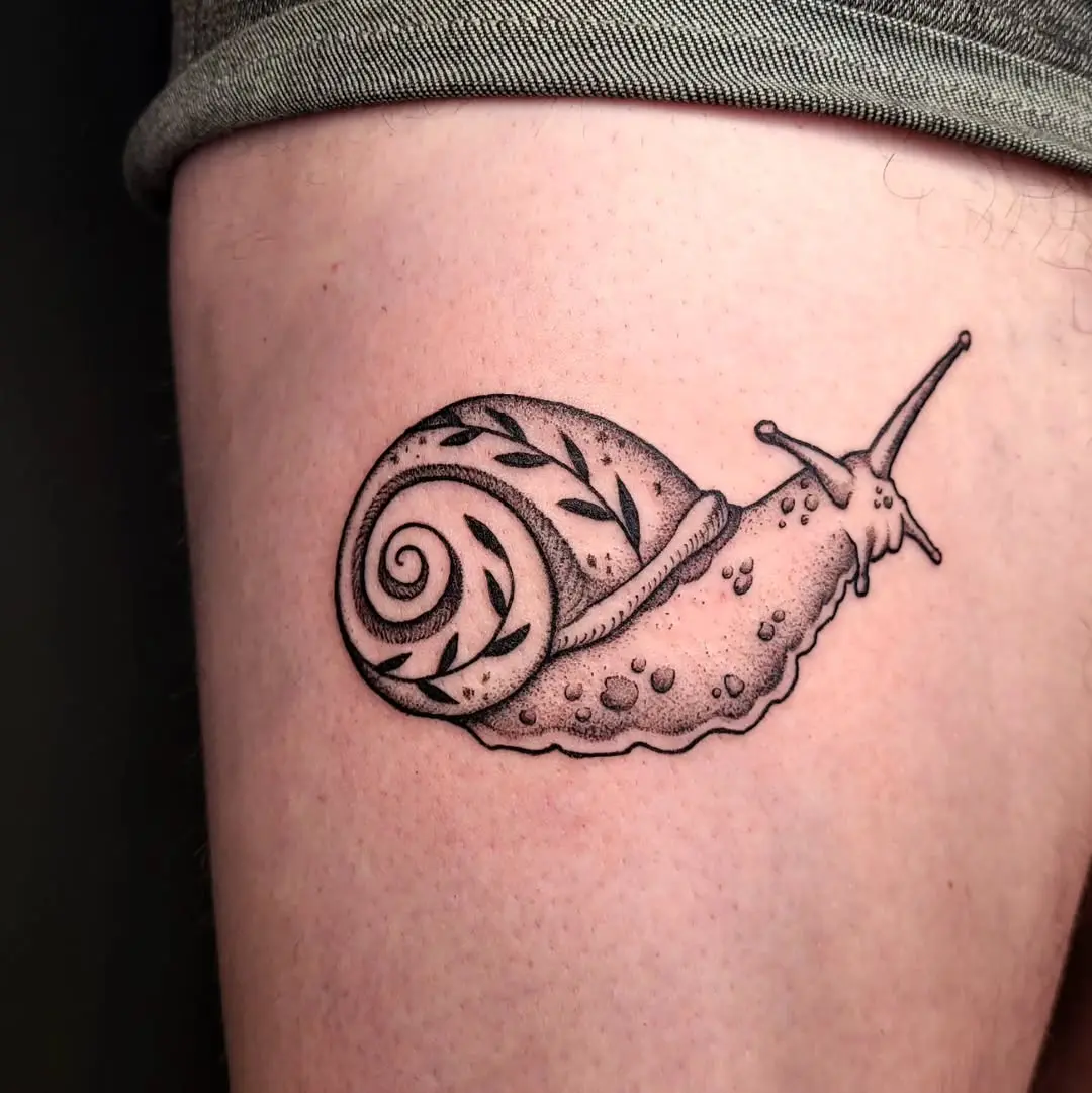 Elegant snail tattoo showcasing nature’s beauty