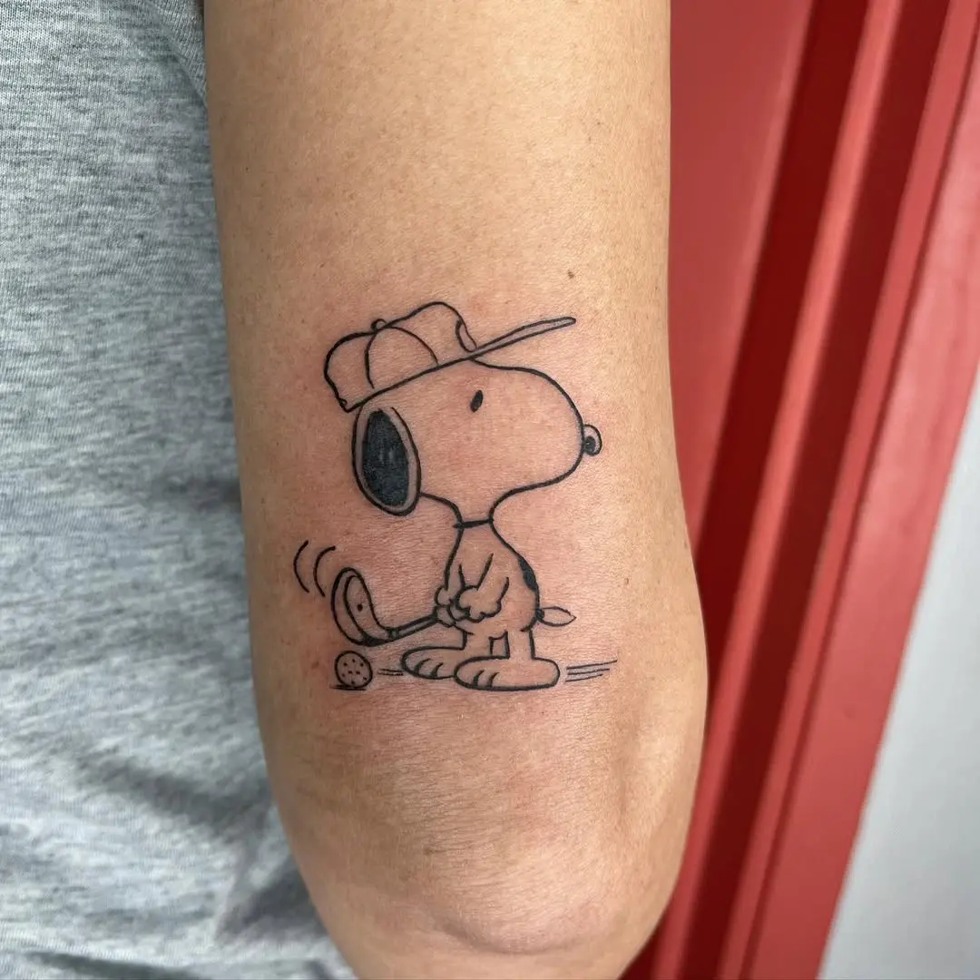 Playful Snoopy Golf Tattoo on Elbow