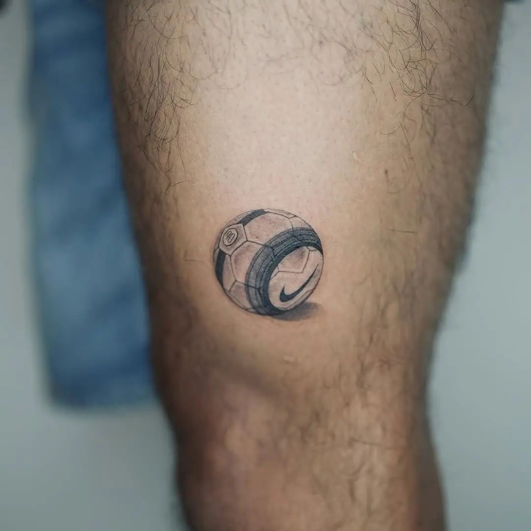 Realistic soccer ball tattoo on leg