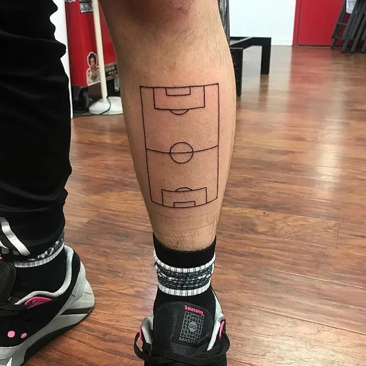 Unique soccer field tattoo on the leg