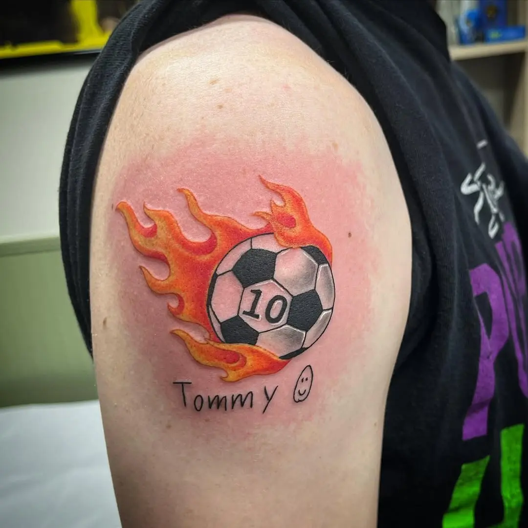 Vibrant flames enhance soccer tattoo design