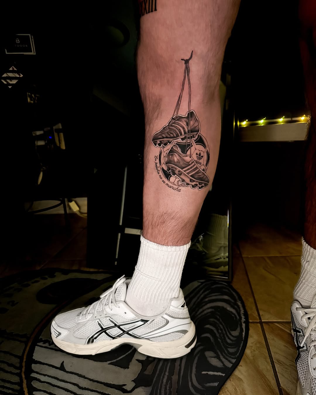 Creative soccer leg tattoo showcasing iconic footwear
