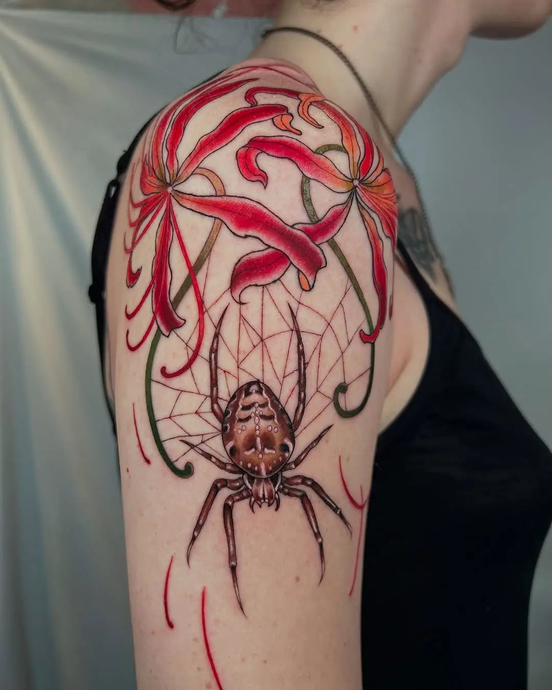 Elegant spider tattoo embracing floral beauty