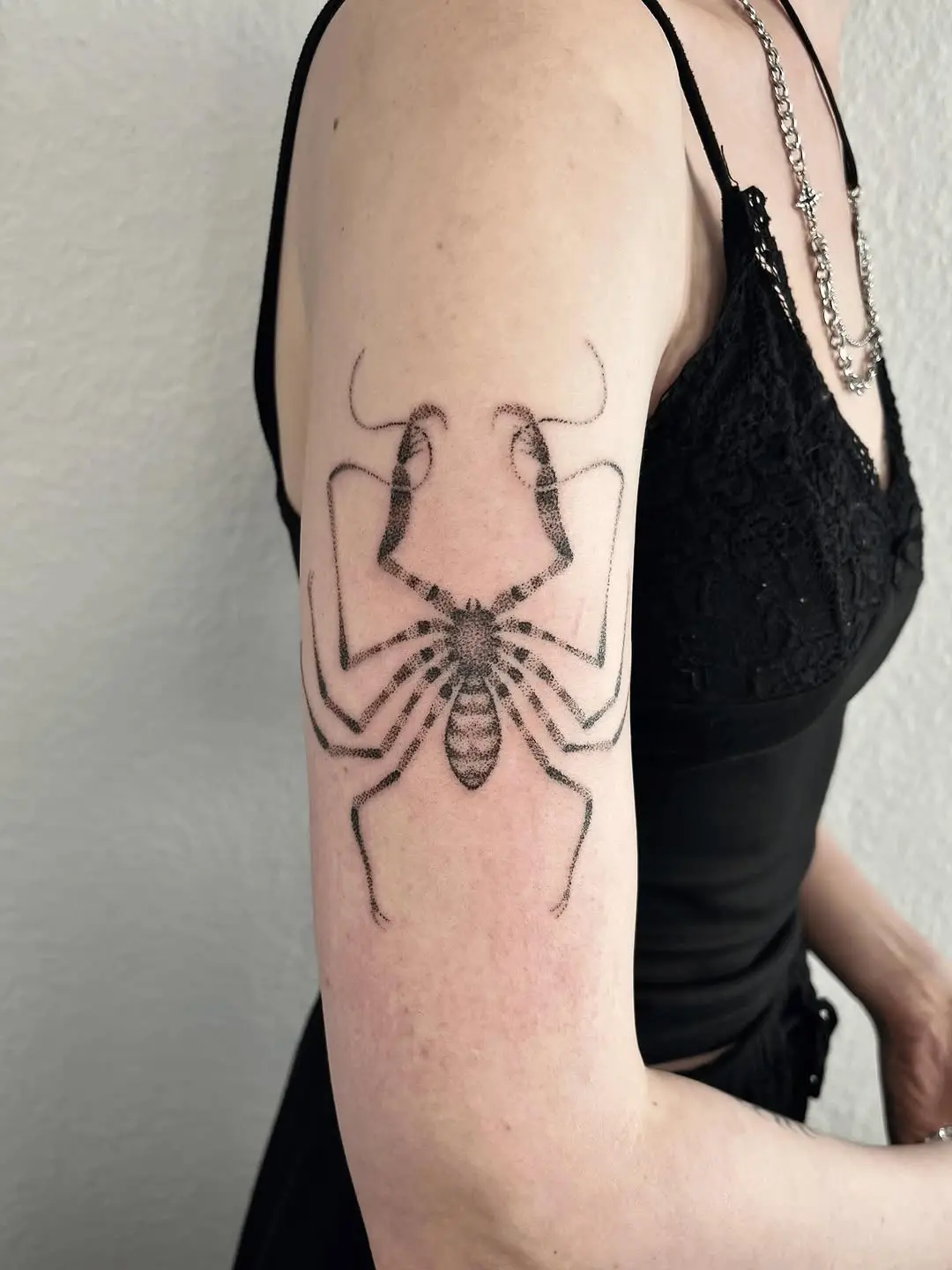 Intricate spider tattoo on a graceful arm