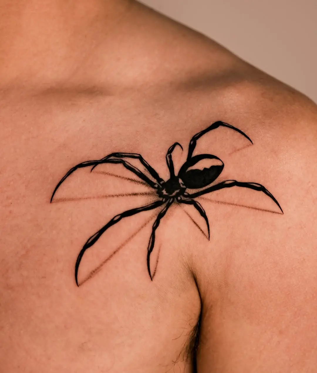 Striking Black Spider Tattoo on Shoulder