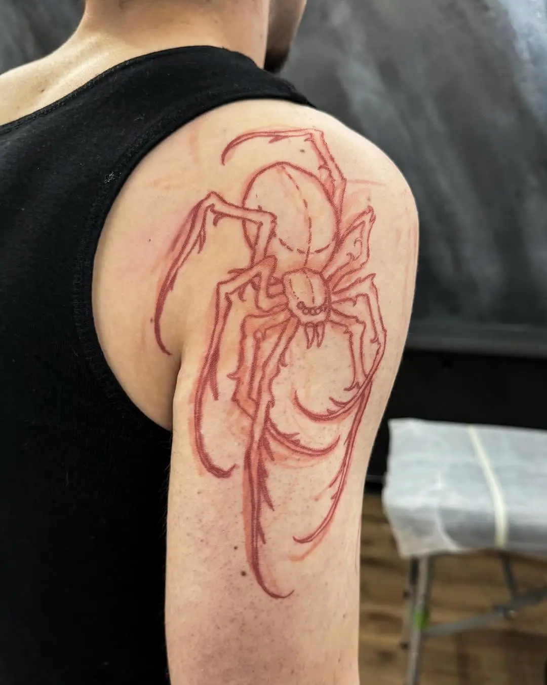 Intricate spider tattoo on shoulder design