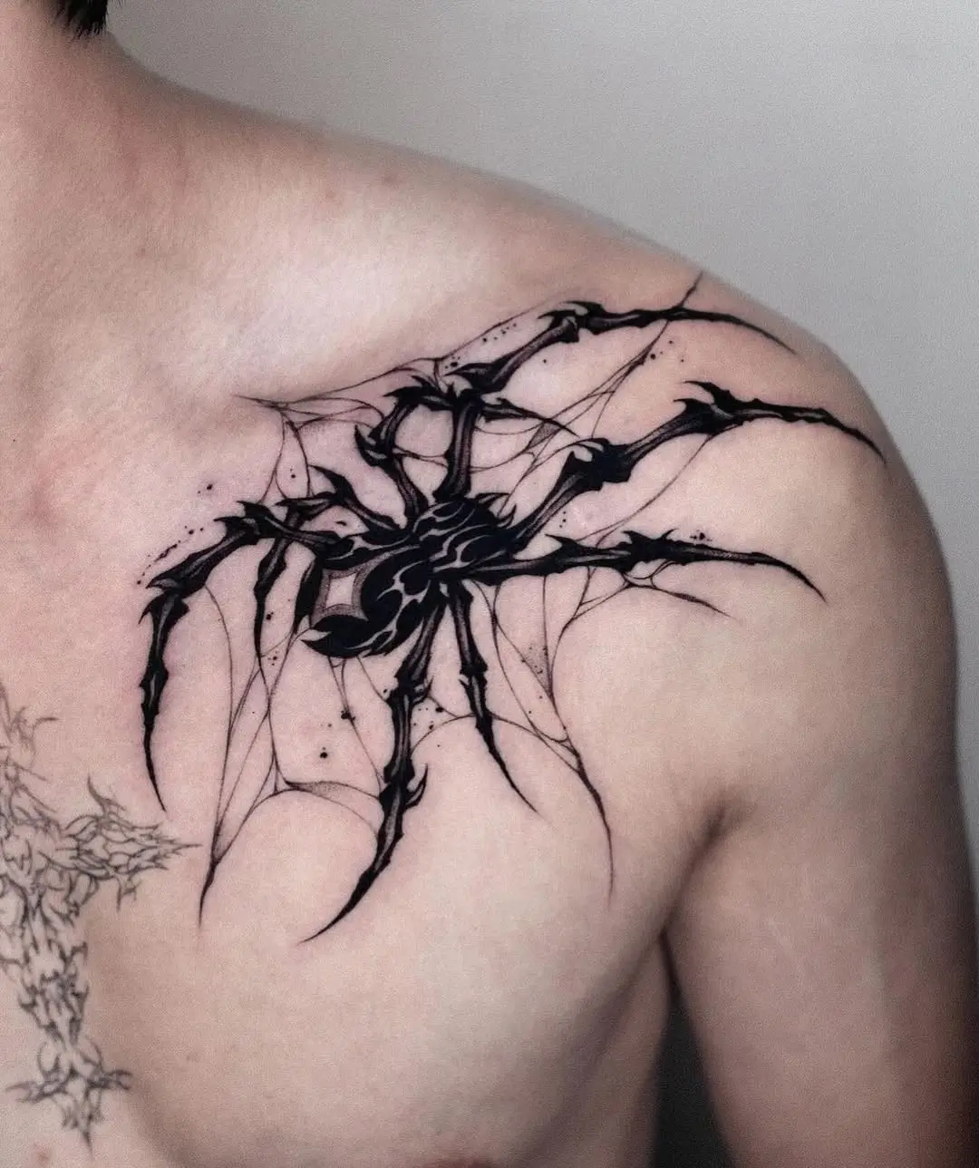 Intricate spider tattoo with web detailing