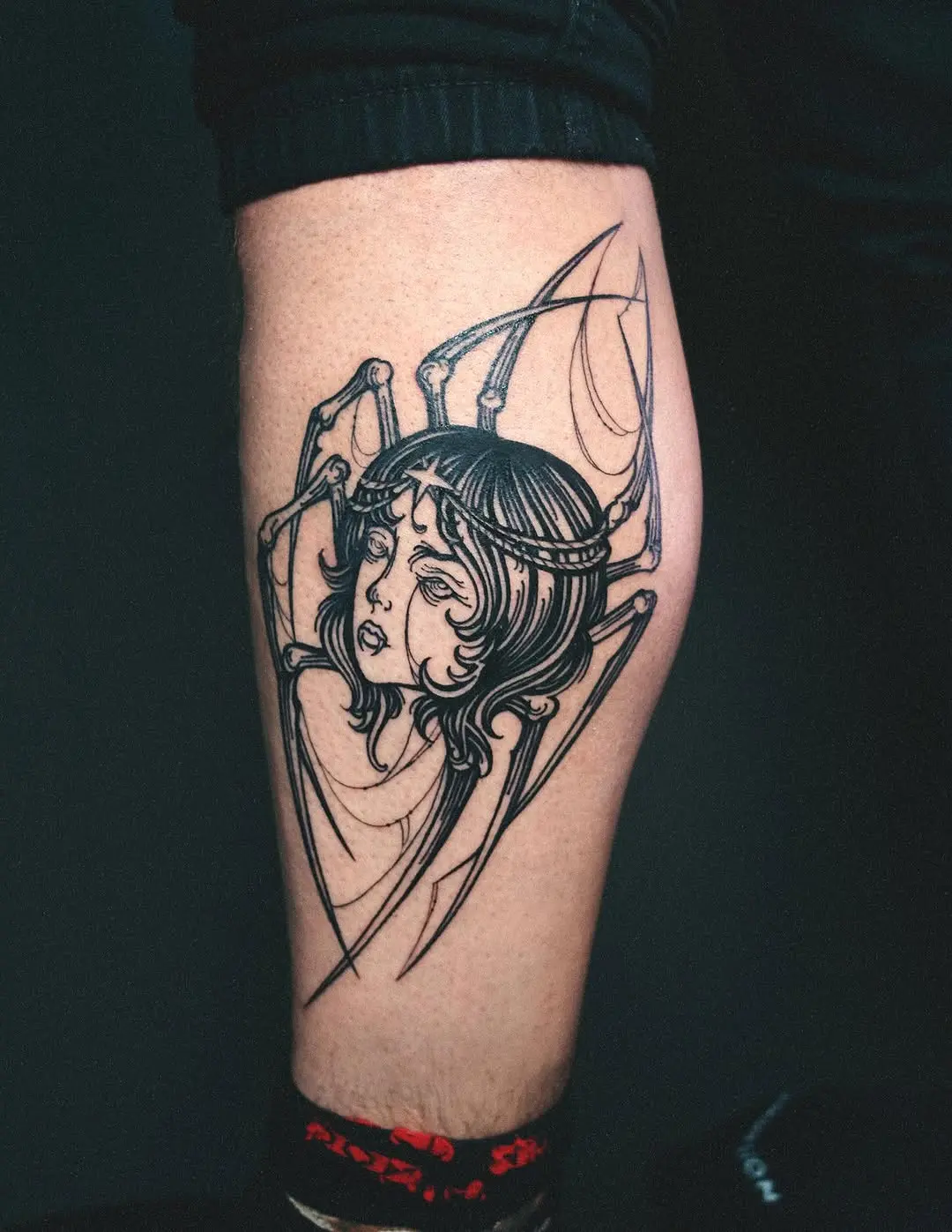 Feminine Spider Tattoo with Artistic Flair