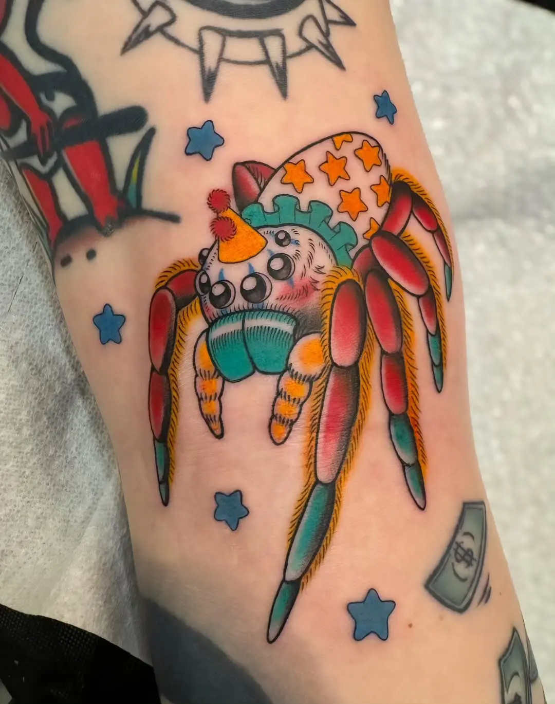 Whimsical spider tattoo with party vibes