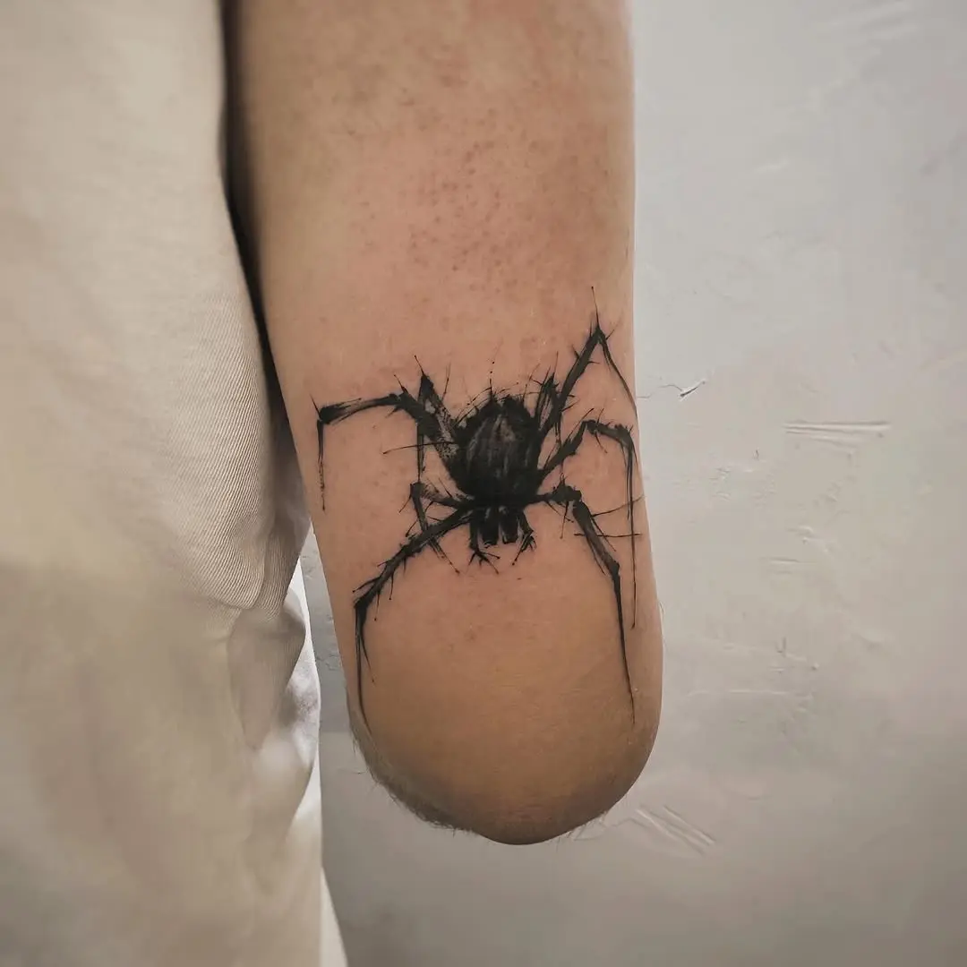 Realistic spider tattoo on forearm