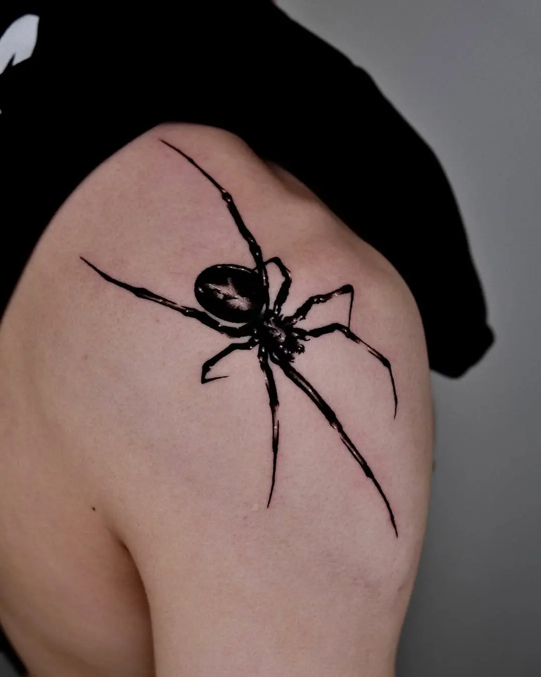 Intricate spider tattoo in bold black ink