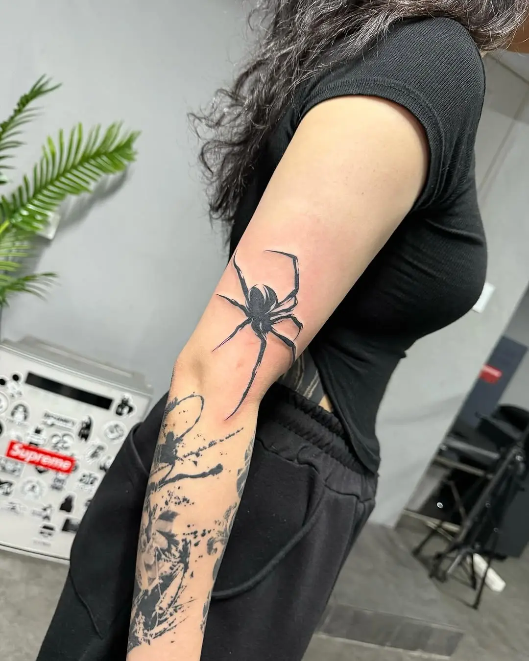 Striking black spider tattoo on arm