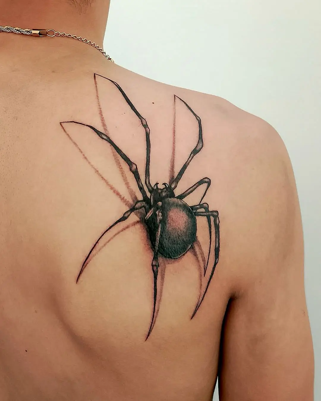 Striking realistic black widow spider tattoo