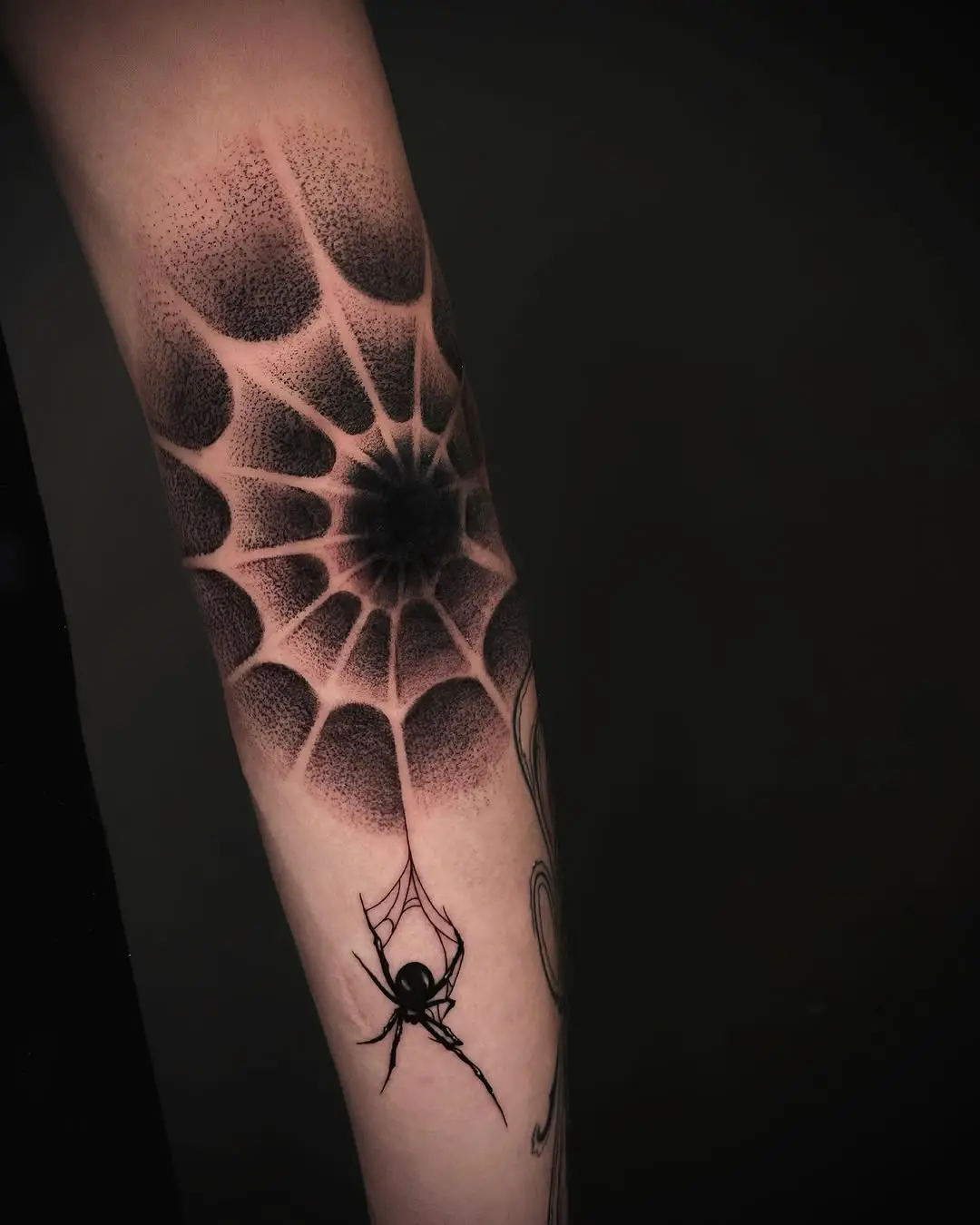 Intricate spider web tattoo with realistic spider