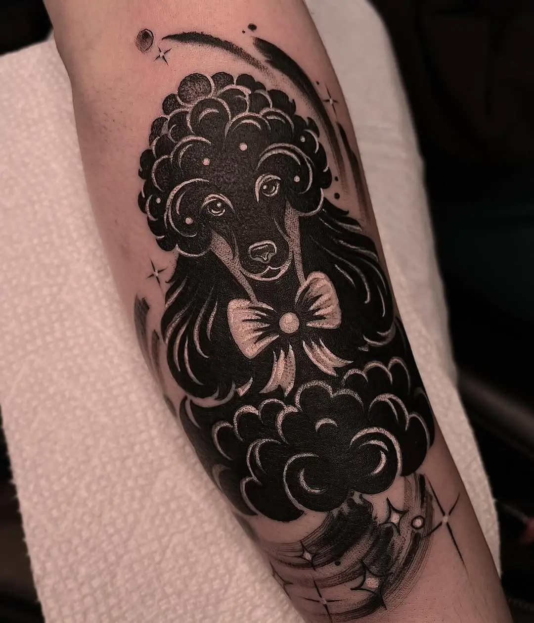 Stylish poodle tattoo with artistic flair