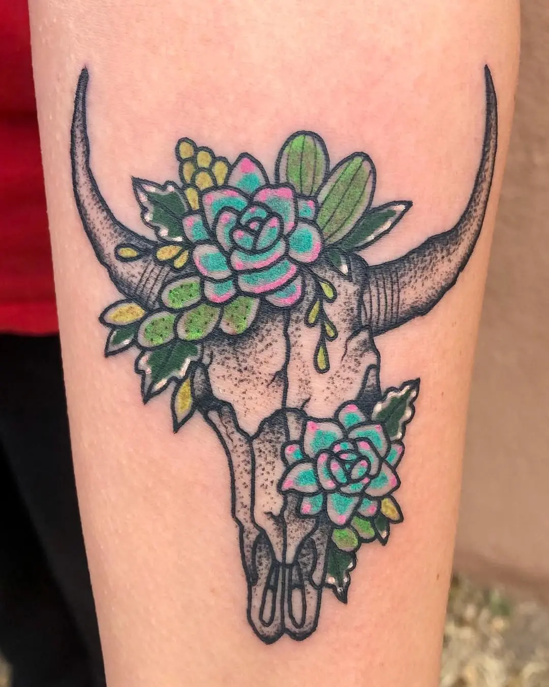 Vibrant succulent tattoo on a skull design