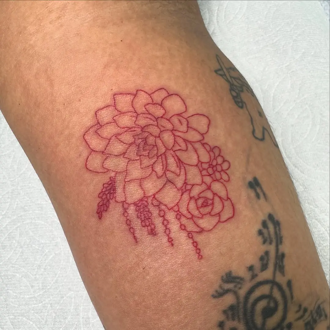 Vibrant red succulent tattoo with fine details