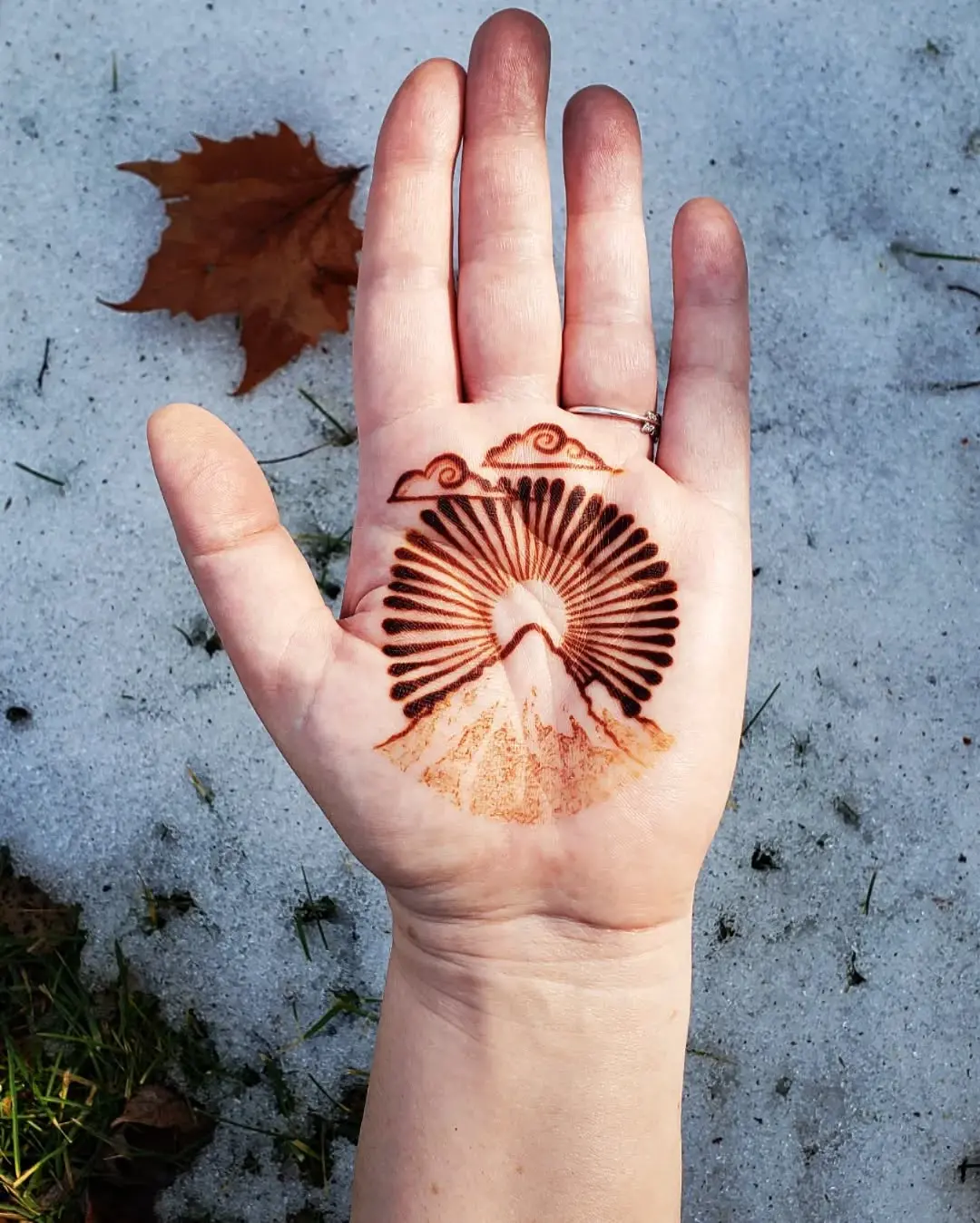 Beautiful sunrise mountain tattoo on palm